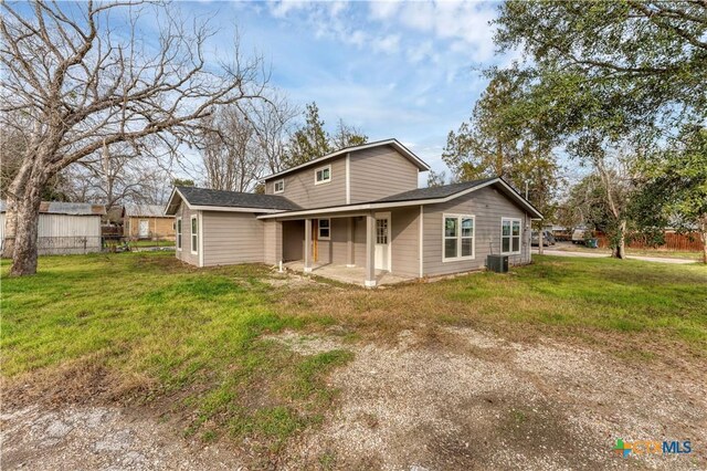 414 Ellis St, Seguin, TX 78155 - rear view of property with fence, central AC, a patio area, and a lawn