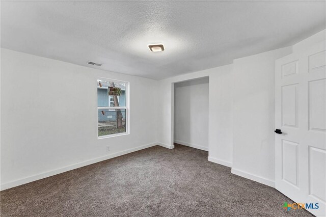 414 Ellis St, Seguin, TX 78155 - unfurnished bedroom with baseboards, carpet floors, a textured ceiling, and visible vents