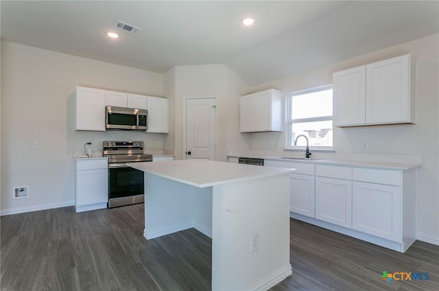 3817 Poteet Ct, Temple, TX 76504 - kitchen featuring dark wood-style flooring, appliances with stainless steel finishes, visible vents, and a kitchen island