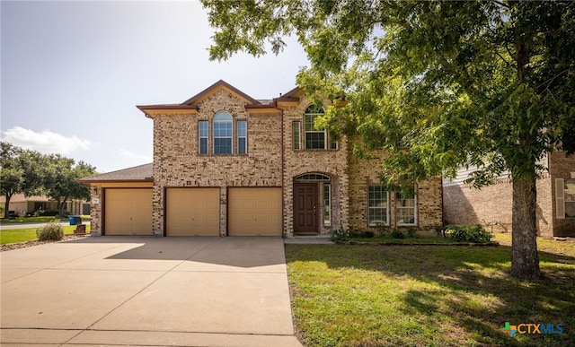 view of front of home featuring a garage and a front lawn