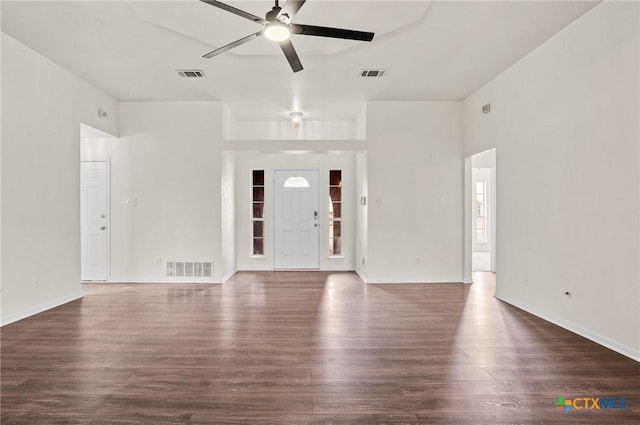 unfurnished living room featuring ceiling fan and dark wood-type flooring