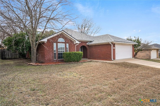 single story home featuring a garage and a front lawn