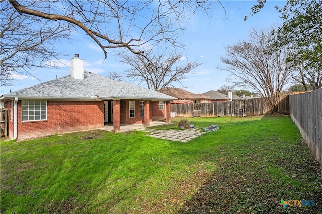 back of house featuring a patio area and a yard