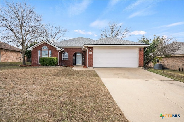 ranch-style house with a garage, cooling unit, and a front lawn