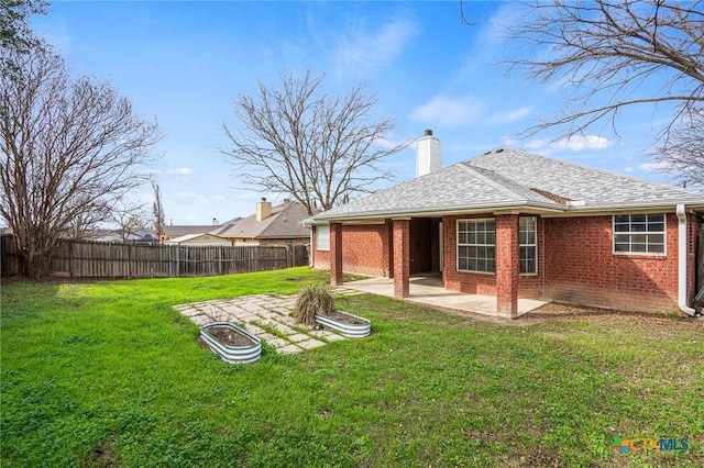 rear view of house with a lawn and a patio area