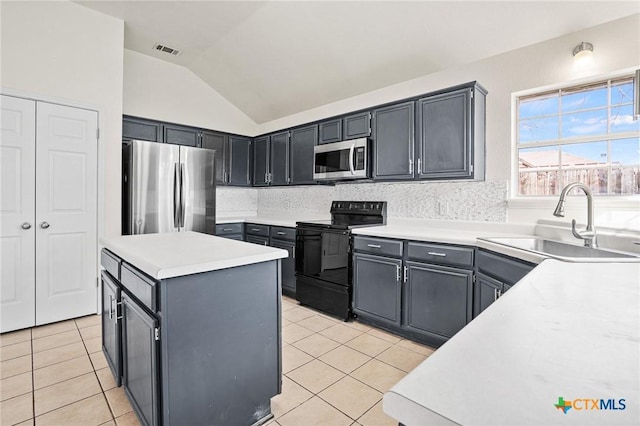 kitchen with sink, decorative backsplash, light tile patterned floors, and appliances with stainless steel finishes