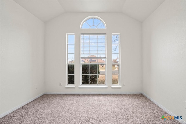 unfurnished room with carpet floors and vaulted ceiling