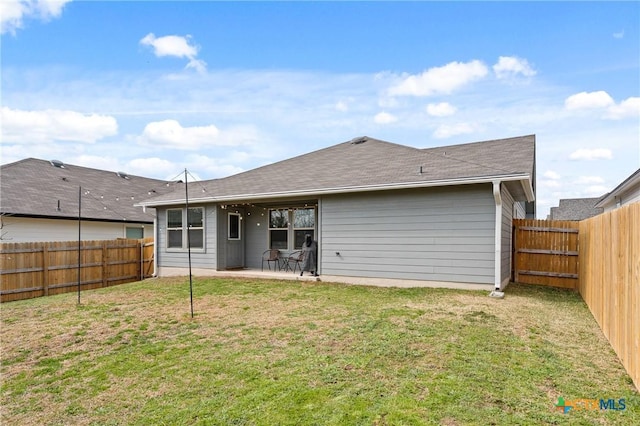 back of property with a patio area and a lawn