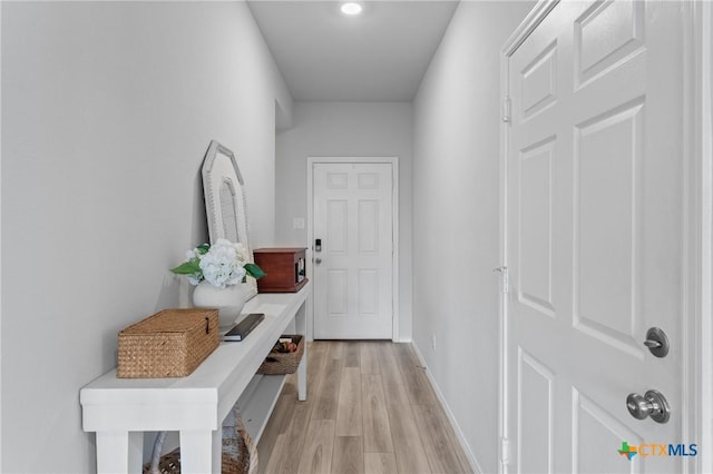 hallway with light hardwood / wood-style flooring