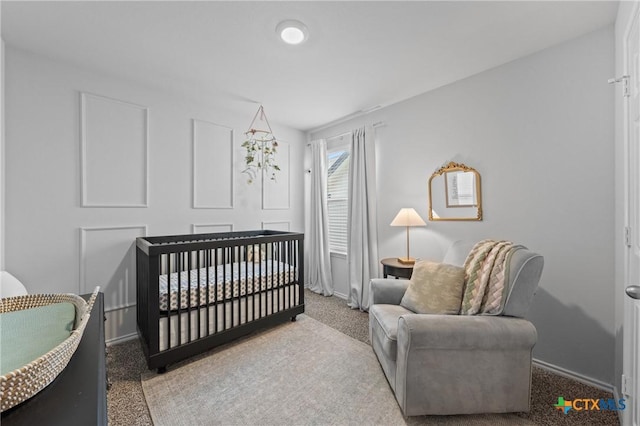 bedroom with light colored carpet and a crib