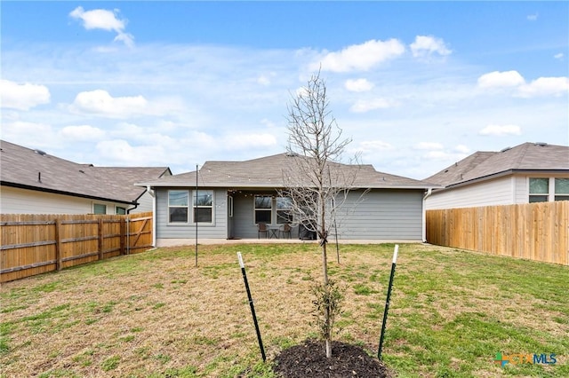 back of house featuring a yard