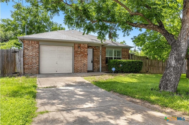 504 Surghnor St, Belton, TX 76513 - view of front of property featuring concrete driveway, brick siding, and an attached garage