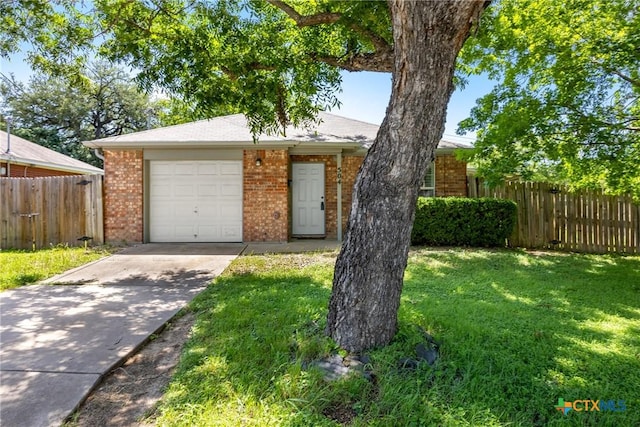 504 Surghnor St, Belton, TX 76513 - view of front of home with driveway, brick siding, and an attached garage