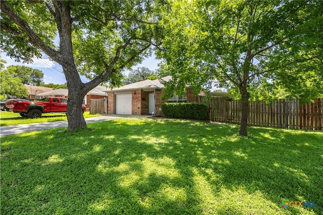 504 Surghnor St, Belton, TX 76513 - view of yard with driveway and an attached garage