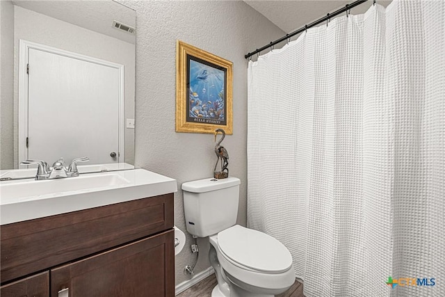 504 Surghnor St, Belton, TX 76513 - bathroom with a textured wall, vanity, wood finished floors, and a shower with shower curtain