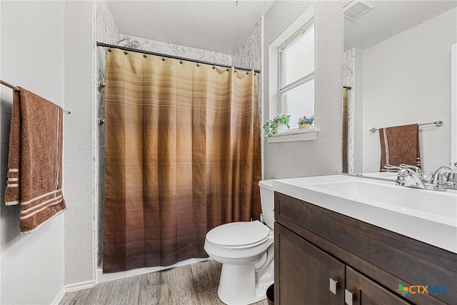 504 Surghnor St, Belton, TX 76513 - full bathroom with vanity, wood finished floors, a textured wall, curtained shower, and a textured ceiling