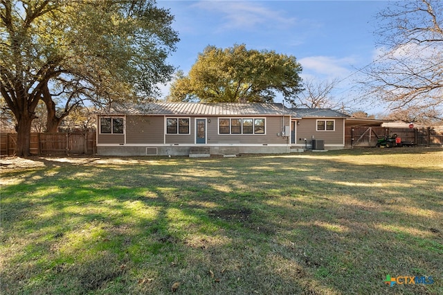 view of front facade with a front yard and central AC