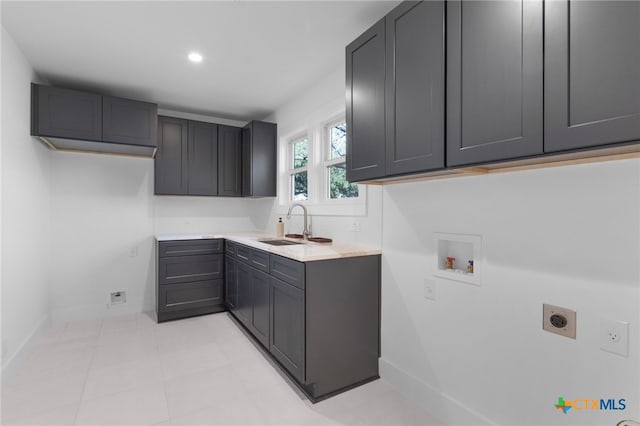 washroom featuring cabinets, washer hookup, electric dryer hookup, and sink