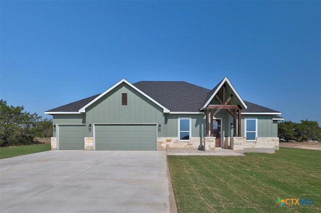 craftsman house with a front yard and a garage