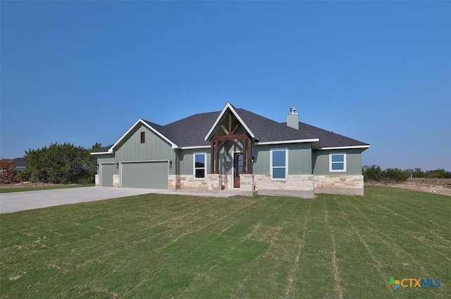 craftsman inspired home featuring a garage and a front lawn