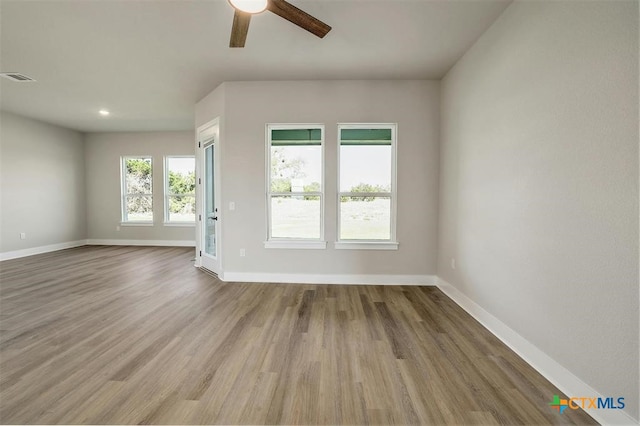 empty room featuring ceiling fan and wood-type flooring