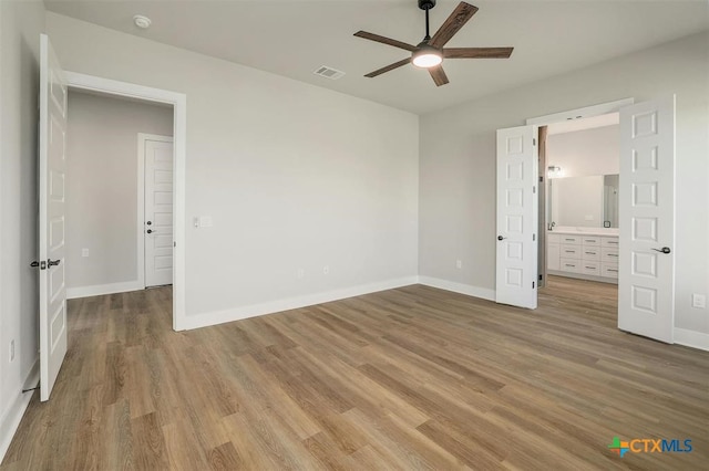 unfurnished bedroom featuring ceiling fan and light wood-type flooring