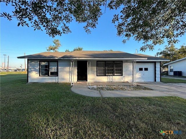 ranch-style house with a garage and a front yard