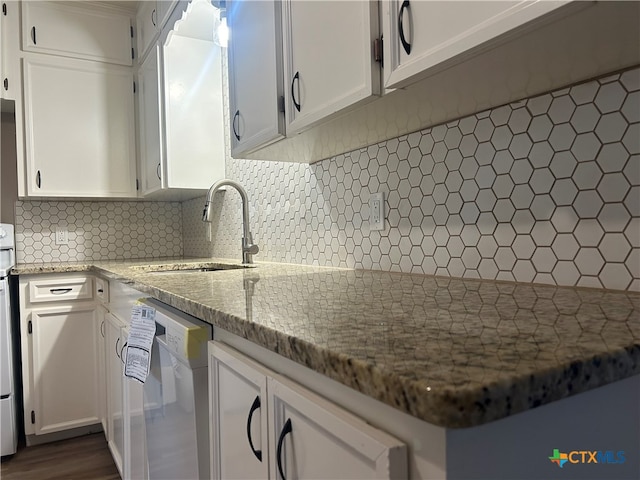 kitchen featuring white cabinetry, light stone counters, backsplash, and white dishwasher