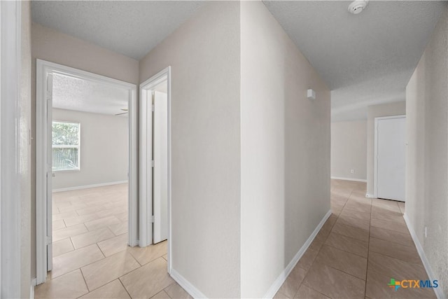 4104 Matt Ct, Killeen, TX 76549 - corridor with light tile patterned floors, a textured ceiling, and baseboards