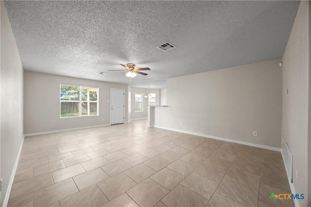 4104 Matt Ct, Killeen, TX 76549 - empty room with ceiling fan, baseboards, a textured ceiling, and light tile patterned floors