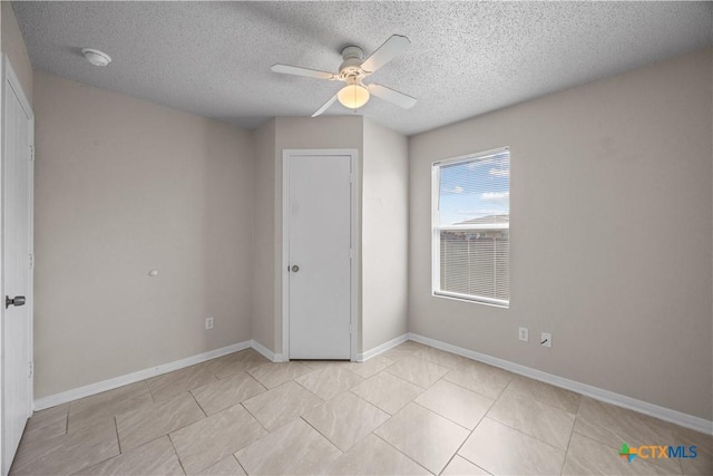4104 Matt Ct, Killeen, TX 76549 - unfurnished bedroom with a textured ceiling, ceiling fan, light tile patterned floors, and baseboards