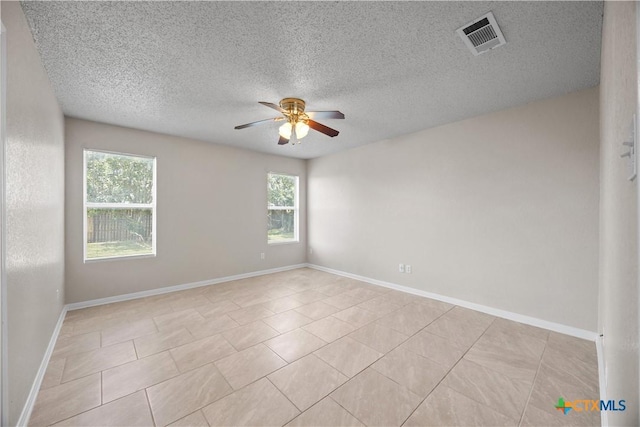4104 Matt Ct, Killeen, TX 76549 - spare room featuring a ceiling fan, plenty of natural light, a textured ceiling, light tile patterned floors, and baseboards