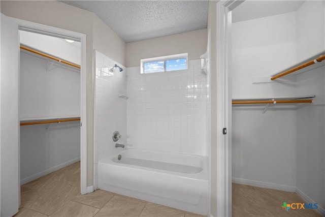 4104 Matt Ct, Killeen, TX 76549 - bathroom with shower / bathtub combination, a walk in closet, a textured ceiling, and baseboards