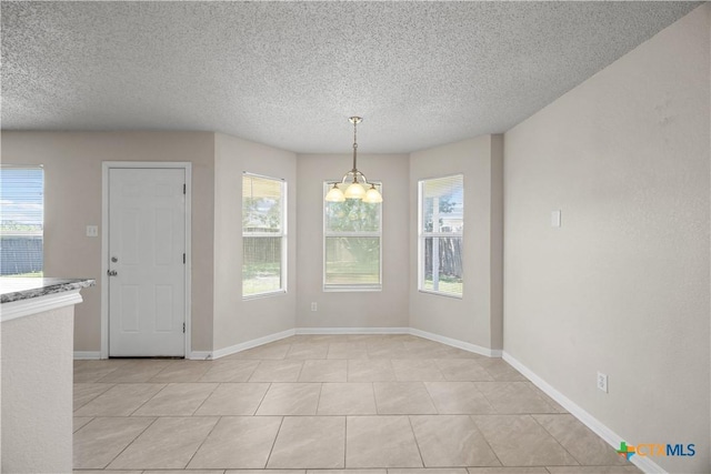 4104 Matt Ct, Killeen, TX 76549 - unfurnished dining area featuring a chandelier, a textured ceiling, baseboards, and light tile patterned flooring