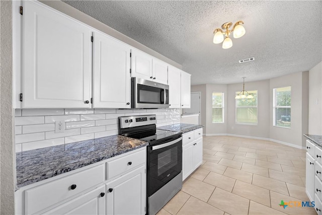 4104 Matt Ct, Killeen, TX 76549 - kitchen with appliances with stainless steel finishes, a textured ceiling, backsplash, white cabinets, and a chandelier