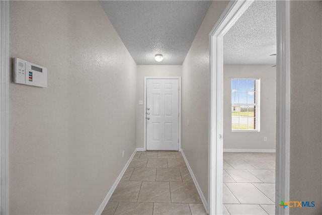 4104 Matt Ct, Killeen, TX 76549 - corridor featuring a textured ceiling, light tile patterned floors, and baseboards