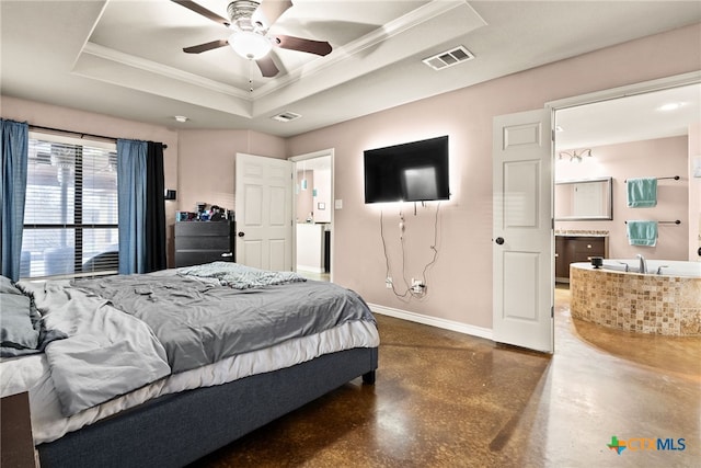 bedroom featuring crown molding, a tray ceiling, and concrete flooring