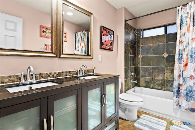 full bathroom with shower / tub combo with curtain, vanity, and toilet