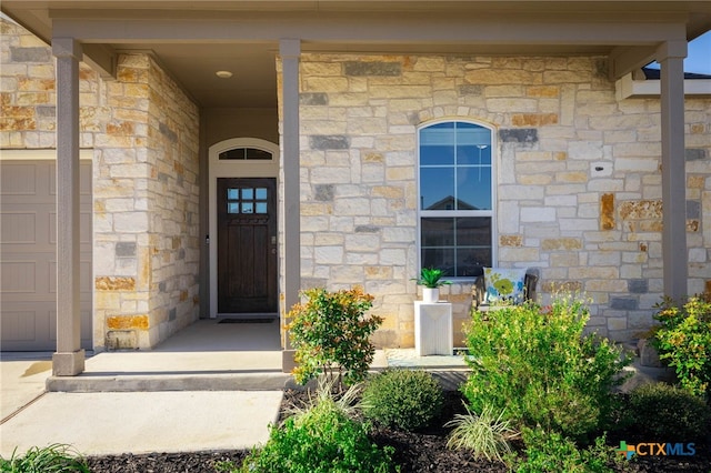 view of exterior entry featuring a garage