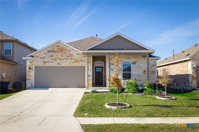 view of front of home with a front yard, a garage, and central AC unit