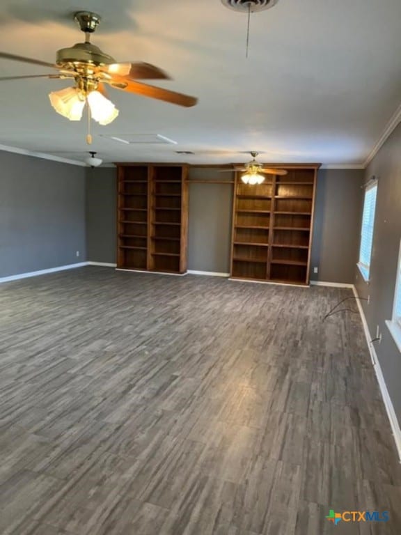 unfurnished living room with ceiling fan, wood finished floors, baseboards, and ornamental molding