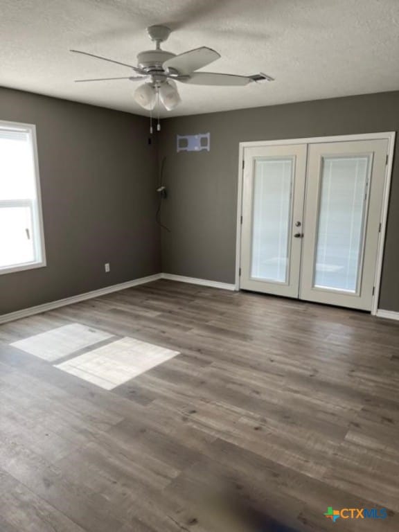 unfurnished room featuring ceiling fan, french doors, baseboards, and wood finished floors