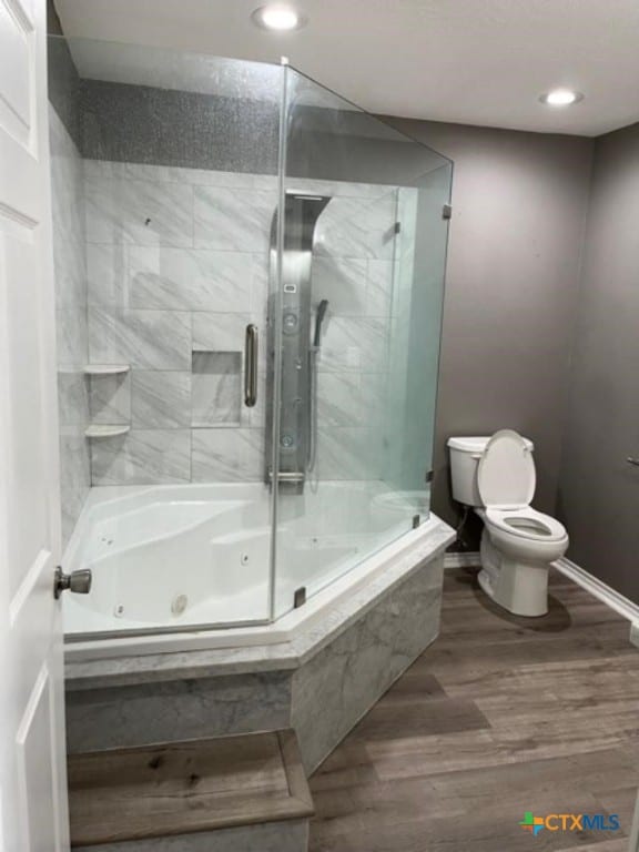 bathroom featuring recessed lighting, toilet, wood finished floors, and baseboards