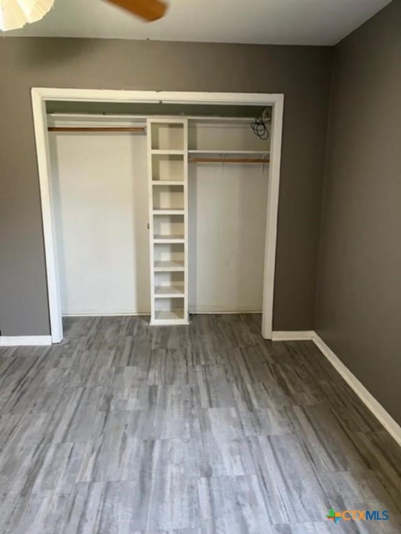 unfurnished bedroom with baseboards and wood finished floors