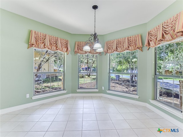 unfurnished dining area with a chandelier and tile patterned floors