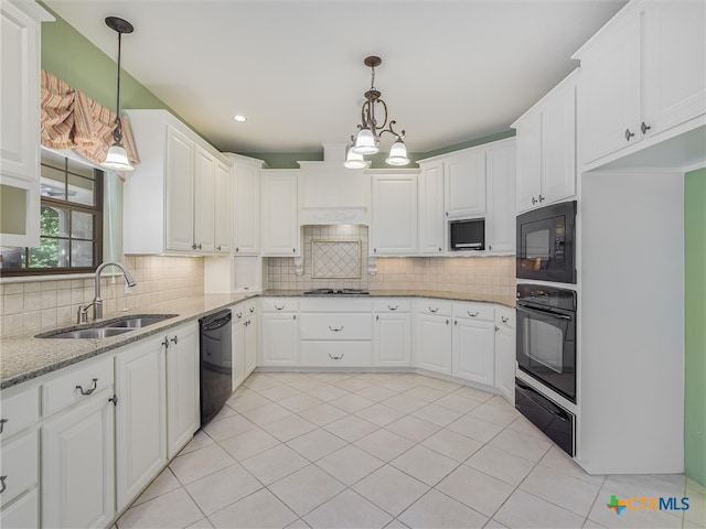 kitchen featuring white cabinetry, black appliances, sink, and pendant lighting