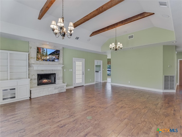 unfurnished living room featuring a fireplace, hardwood / wood-style flooring, a chandelier, and vaulted ceiling with beams