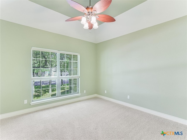 carpeted empty room featuring ceiling fan