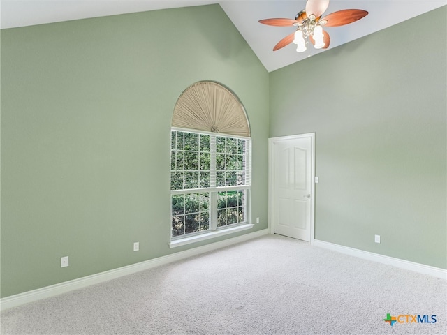 empty room featuring carpet flooring, high vaulted ceiling, and ceiling fan