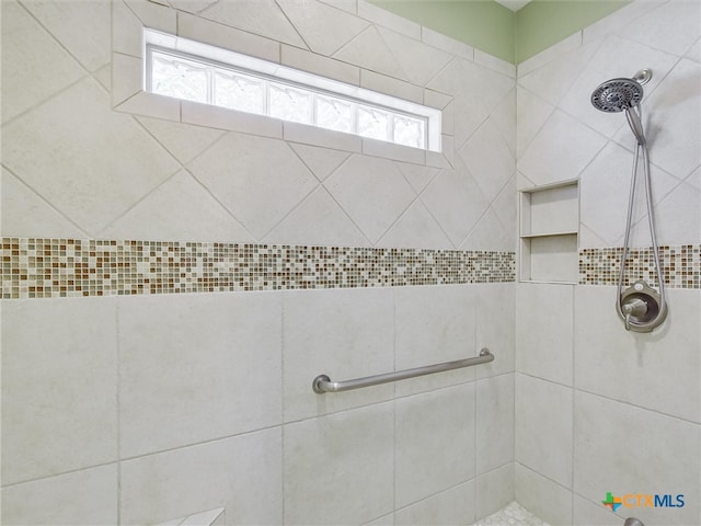 bathroom with a tile shower